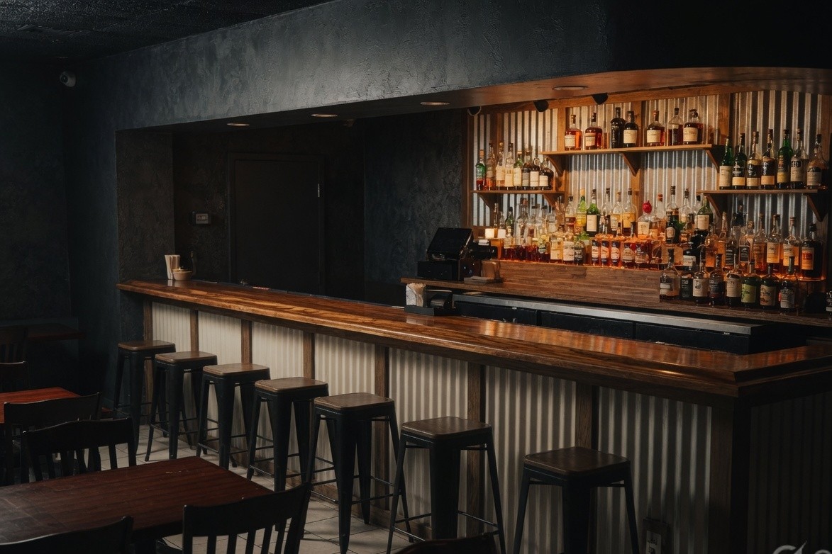 Full bar with liquor shelves at Bottomz Up