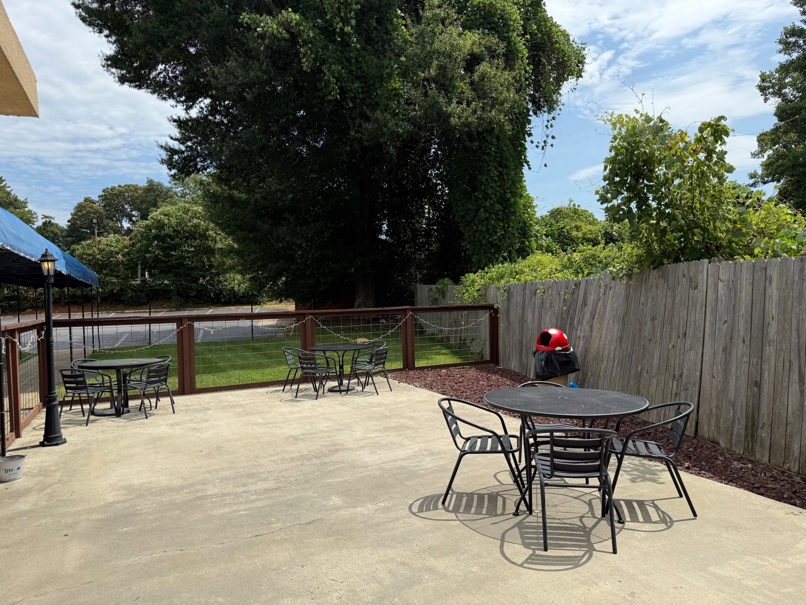 Outdoor patio tables and lawn at Bottomz Up